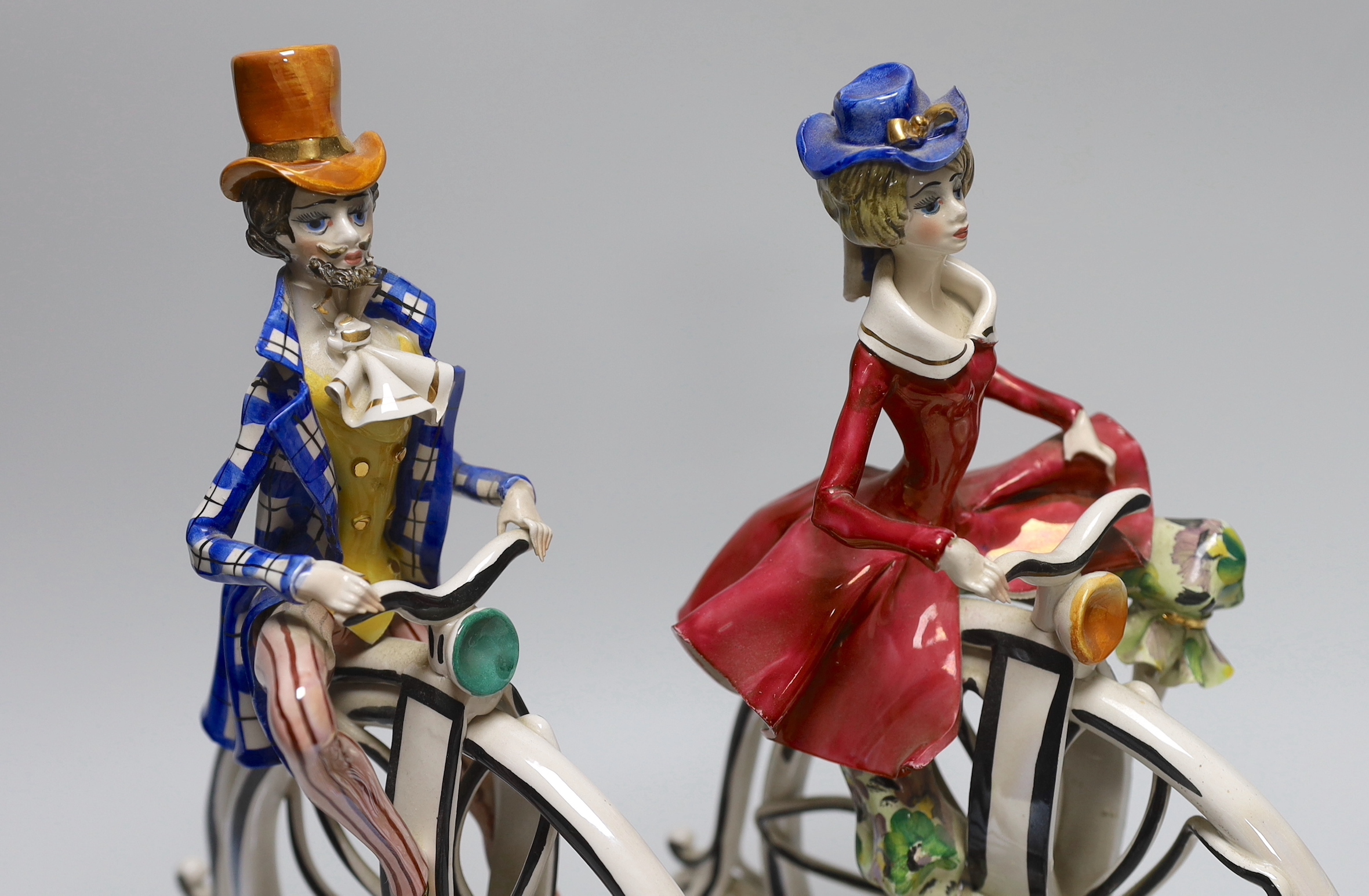 A pair of 1950’s- 60’s Italian ceramic penny farthing cyclists, 31cm